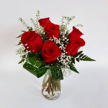Arrangement dans un vase de roses rouges (6-9-12)